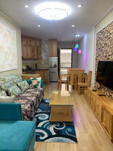 a living room with a couch and a dining room at Panaroma Apartment Đà Lạt in Da Lat