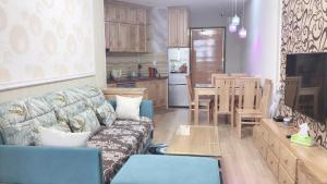 a living room with a couch and a kitchen at Panaroma Apartment Đà Lạt in Da Lat