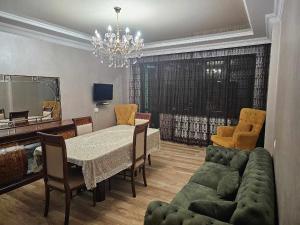 a living room with a table and a couch at RUSO'S APARTMENT in Kobuleti