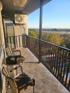 a balcony with a table and chairs and a view at RUSO'S APARTMENT in Kobuleti