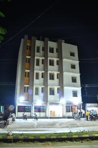 a large building with motorcycles parked in front of it at Hotel Kalika Residency in Akalkot