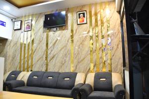 a conference room with chairs and a wall with trees at Hotel Kalika Residency in Akalkot