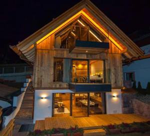 a house with a lot of windows on top of it at Mountain Chalet Ghilga in Ortisei