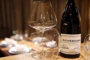 a wine glass sitting next to a bottle of wine at Mountain Chalet Ghilga in Ortisei