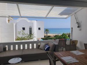 a living room with a couch and a table at bel appartement vue sur mer in Nabeul +11 photos