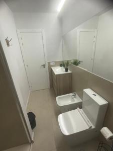 a white bathroom with a sink and a toilet at Casa Palmera in Costa de Antigua +16 photos