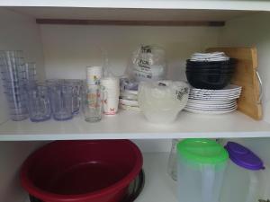 a white shelf with plates and bowls and other items at Villa with Titiwangsa Hill View in Kerling