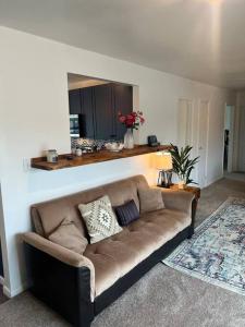 a living room with a brown couch in a room at Lake View Retreat in Cambridge