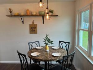 a dining room with a table with chairs and a tableablish at Lake View Retreat in Cambridge