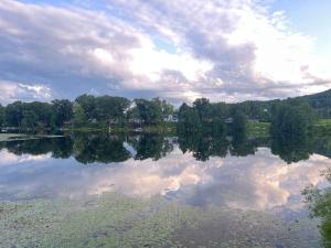 a lake with a reflection of clouds in the water at Lake View Retreat in Cambridge