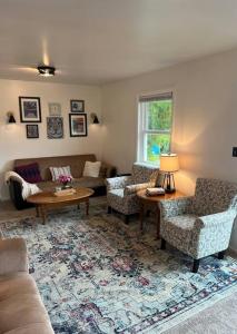 a living room with a couch and chairs and a table at Lake View Retreat in Cambridge