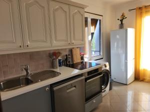 a kitchen with a sink and a refrigerator at Villa Rose in Le Muy