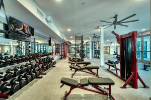 a gym with a bunch of treadmills and machines at Cozysuites PHX RORO Gym, Pool, Pets, Parking! #9 in Phoenix