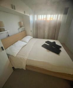 a bedroom with a white bed with a robe on it at Casa Palmera in Costa de Antigua