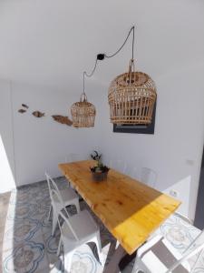 a dining room with a wooden table and chairs at Villa Stefi in Playa Blanca