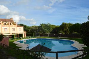 una gran piscina frente a una casa en augustha resort, en Islantilla