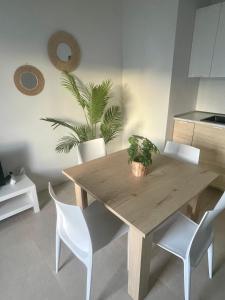 a wooden table and chairs in a kitchen with a plant at Casa Palmera in Costa de Antigua