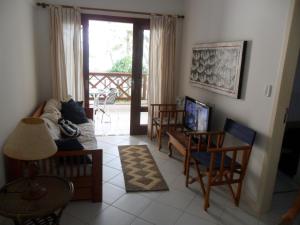 TV a/nebo společenská místnost v ubytování Enseada Praia Do Forte - Vista Mar