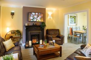 a living room with a couch and a fireplace at Waterfront Self Catering Houses in Carrick on Shannon