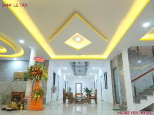 a lobby of a hotel with a yellow ceiling at Khách Sạn Hưng Yên in Phu Quoc