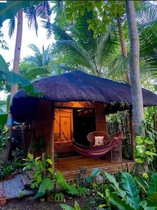 a small hut with a hammock in front of it at DJs Beach Resort in Union