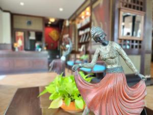 a statue of a woman in a dress on a table at Lanta Mermaid Boutique House in Ko Lanta