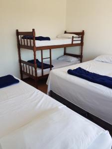 a group of four beds in a room at Hostel BoituVillage in Boituva
