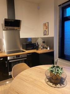 een keuken met een tafel en een aanrecht bij Maison de ville - 4 personnes - Ô coeur de Spa in Spa