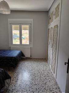 a white room with a bed and a window at CASA ANTONIO Y GABI Ruta de los dinosaurios in Igea