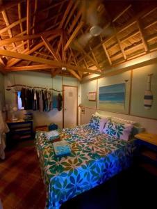 a bedroom with a bed with a blue comforter at DJs Beach Resort in Union