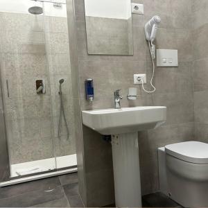 a bathroom with a toilet and a sink and a shower at Villa Angeli in Rome