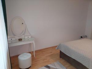 a bedroom with a bed and a dressing table with a mirror at 3-rooms apartment for up to 4 persons near to Prater in Vienna