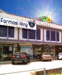 a hotel with cars parked in front of it at G Six Hotel in Sitiawan