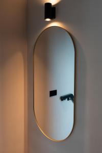 a bathroom with a mirror on the wall at Spacious & Chic House in Center in Kortrijk