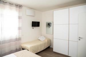 1 dormitorio con 2 camas y puerta corredera de cristal en Maisonette Modena Park, en Módena