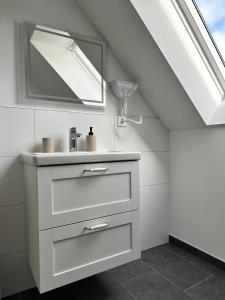a bathroom with a sink and a mirror at Lagom - Apartments an der Barclays Arena in Hamburg