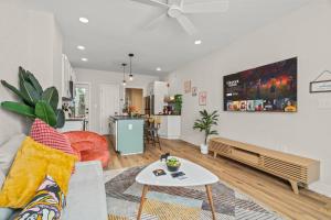 a living room with a couch and a table at Passyunk Square Spacious 1 BR Oasis- Huge Deck in Philadelphia