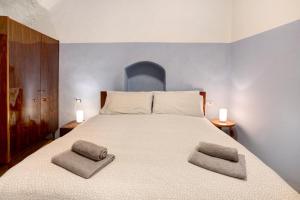a bedroom with a large bed with two pillows on it at Casa Bianca in Bormio