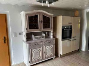 a kitchen with a white cabinet and a stove at Franzis Landhaus in Singen