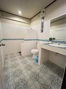 a bathroom with a toilet and a sink at Haad Khuad Resort in Bottle Beach