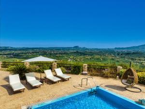 a villa with a swimming pool with a view at Amorosa Villas in Lagópodhon