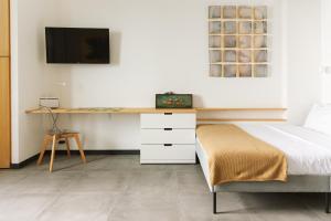 a bedroom with a desk and a bed at Cà de Mâ Ω Sea Front Apartment in Genoa