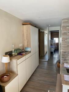 a kitchen with white cabinets and a wooden floor at White Paradise in Val-d'Isère