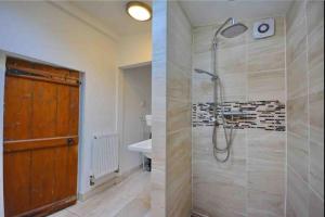 a bathroom with a shower and a sink at Dale Cottage 18th Century Country Cottage, 111 Barnston road in Heswall
