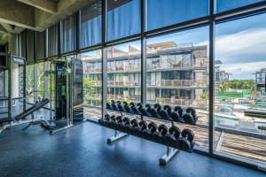 a gym with lots of windows and machines at Divine 2BR Tulum on Cenote Gym in Tulum