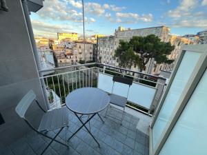 a table and chairs on a balcony with a view at Balcony House in Naples