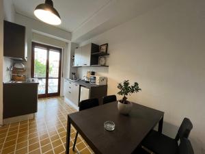 a kitchen with a table with a plant on it at Balcony House in Naples