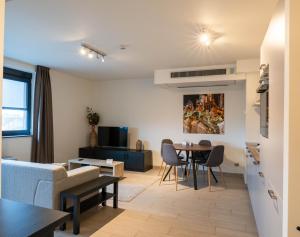 a living room with a couch and a table at Tower Hotel Aalst in Aalst