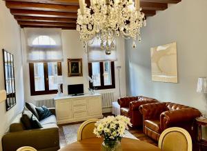 a living room with couches and a chandelier at SANTA CATERINA: charming apartment TREVISO in Treviso