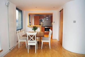 a kitchen and dining room with a table and chairs at ALTIDO Inviting flat with parking in Canonmills in Edinburgh